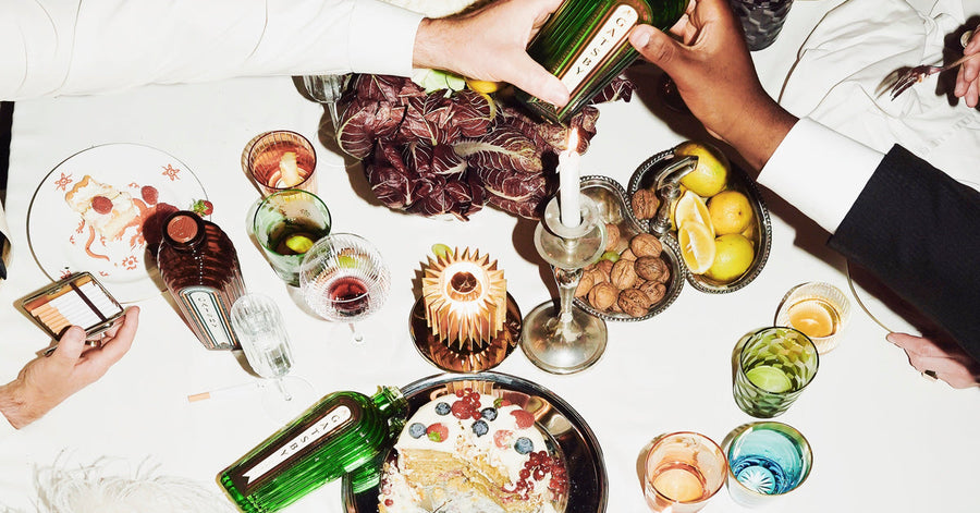 Bottles of Gatsby Gin passed across a crowded table.