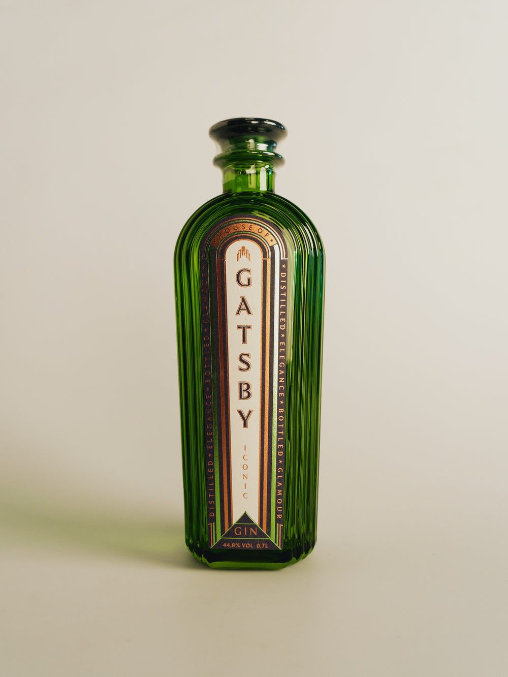 The Gatsby Gin bottle photographed straight on, showing the stepped Art Deco shoulders and fluted glass